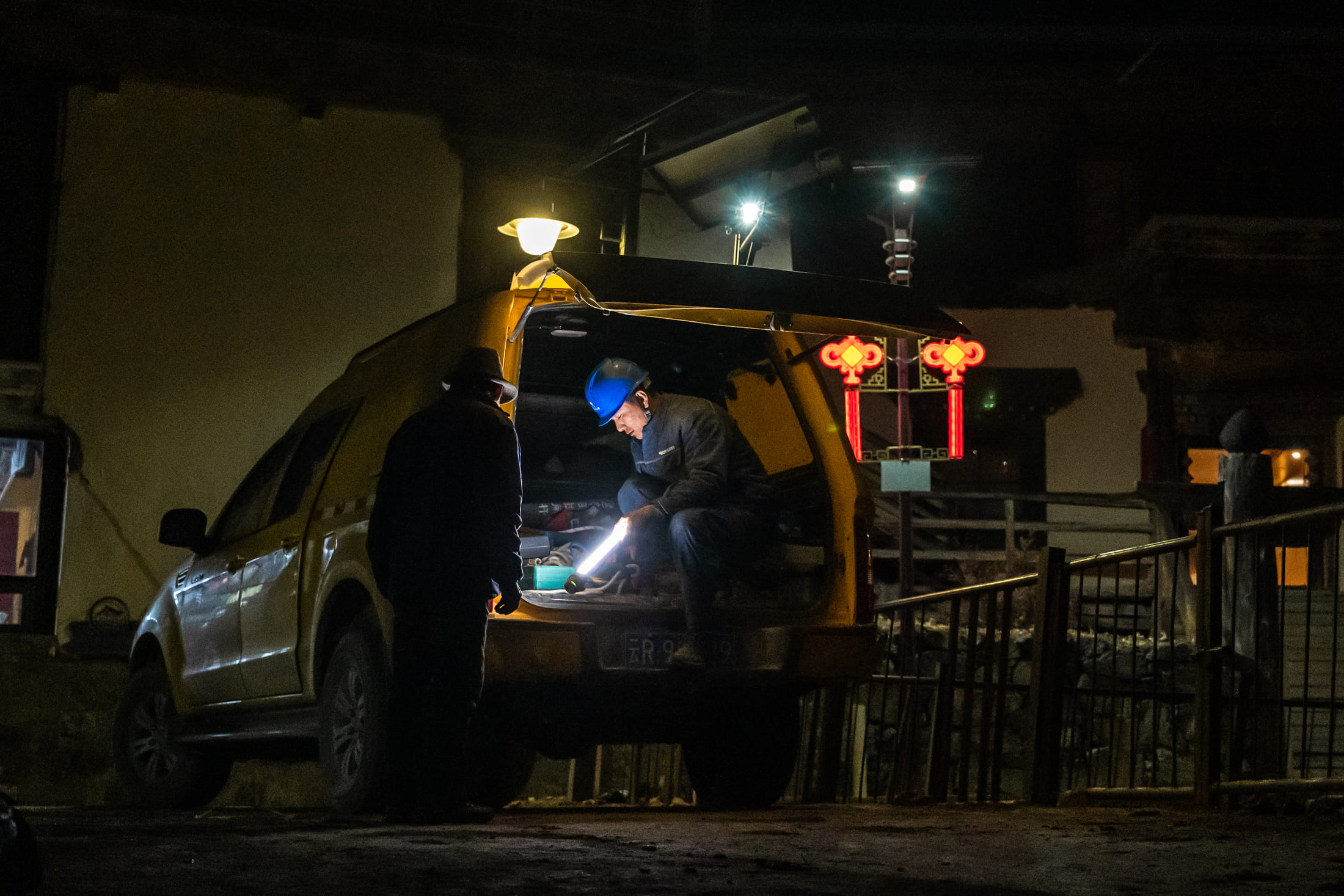 Wangden prepares equipment before inspecting power lines in Yubeng Village, Deqen County, Yunnan Province